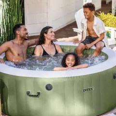 Famille souriante profitant d'un moment de détente dans un spa gonflable vert, créant une bulle de bonheur et d'isolation.