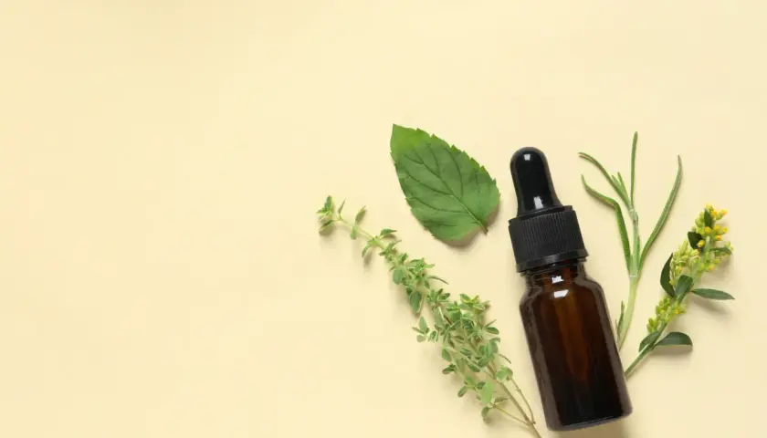 Flacon d'huile essentielle avec des herbes. Un remède naturel pour la toux sèche.