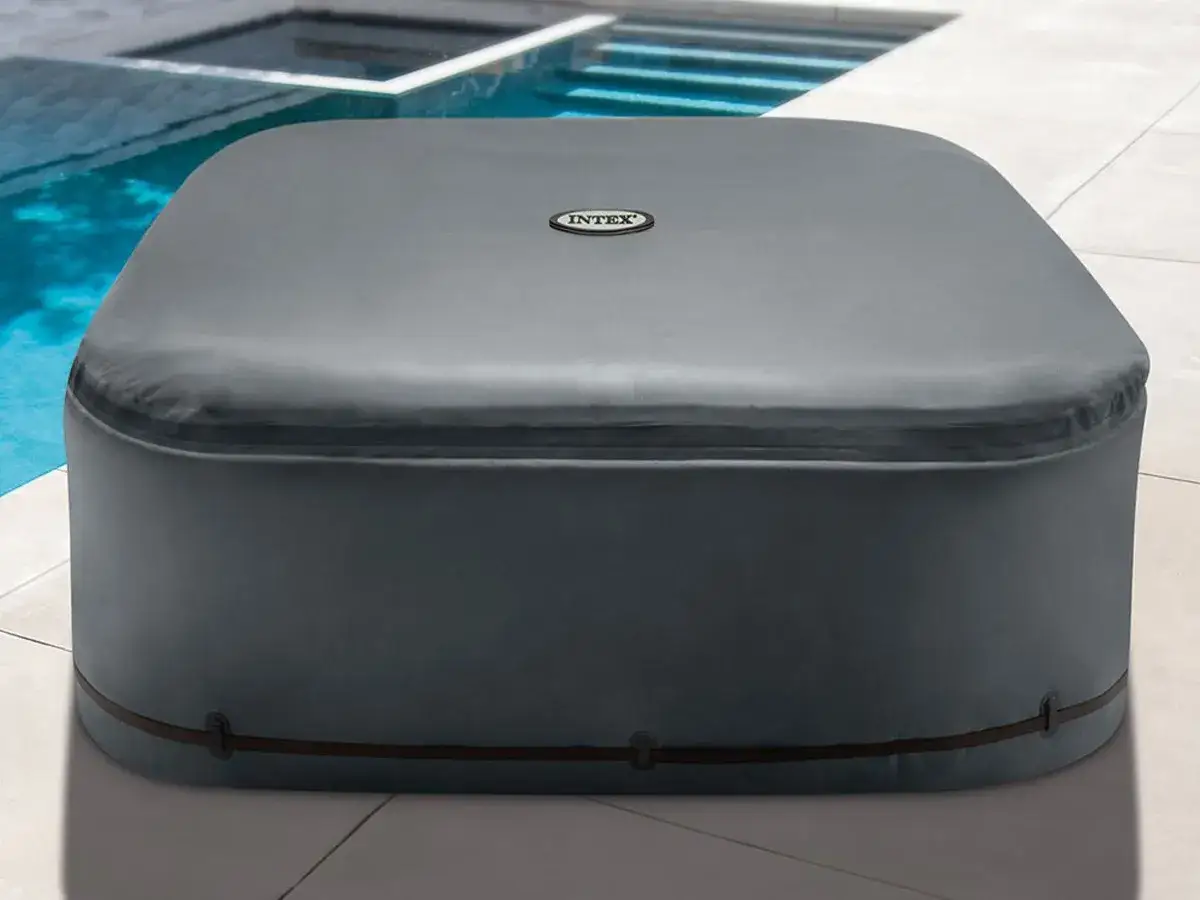Un spa gonflable Intex couvert, pr&ecirc;t pour l'hiver ou pour garder l'eau propre. L'isolation est assur&eacute;e par sa housse grise.